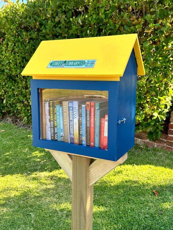 A blue and yellow version of Street Library Australia's 'The Shed'.